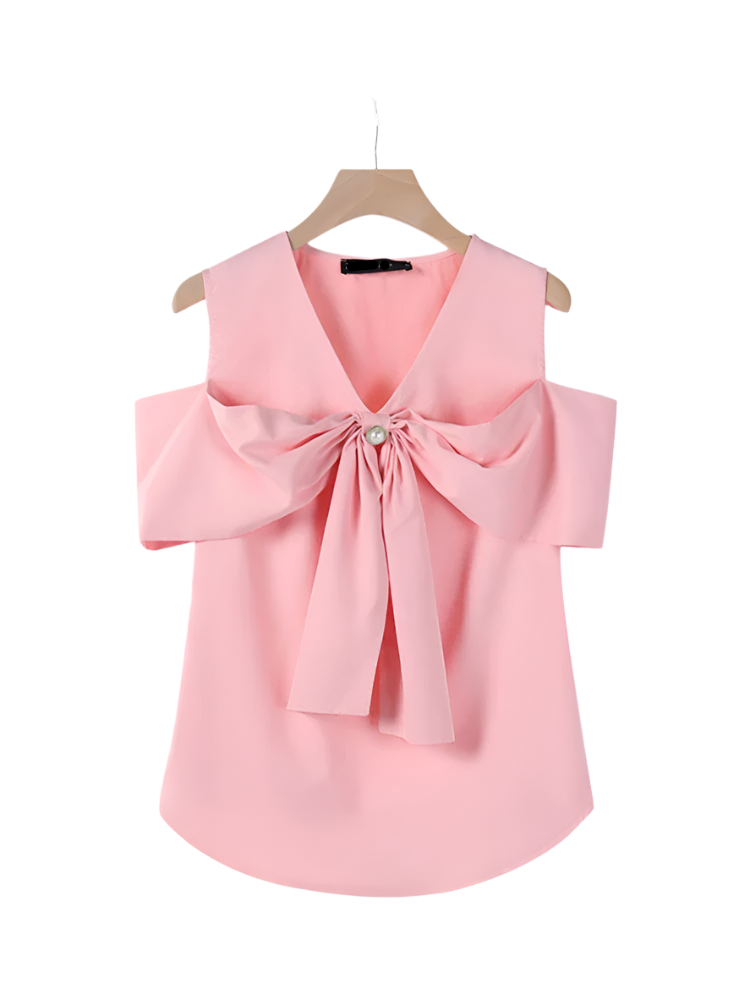Pink blouse with a large bow on a hanger against a white background