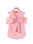 Pink blouse with a large bow on a hanger against a white background