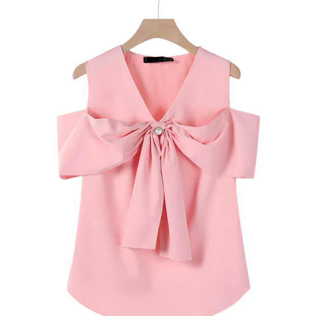 Pink blouse with a large bow on a hanger against a white background