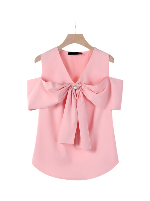 Pink blouse with a large bow on a hanger against a white background
