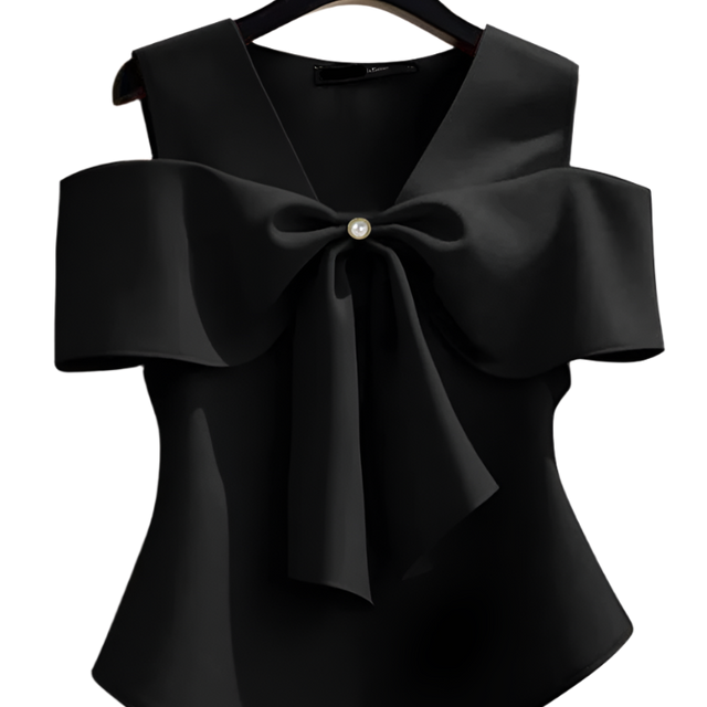 Black blouse with a large bow on a hanger against a neutral background