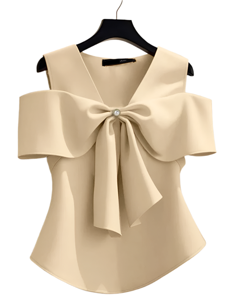 Beige blouse with a large bow detail on a hanger against a neutral background