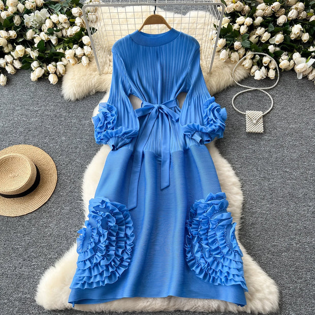 Blue dress with floral details on a textured surface with decorative elements