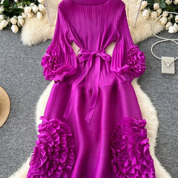 Purple dress with floral details on a hanger against a decorative background