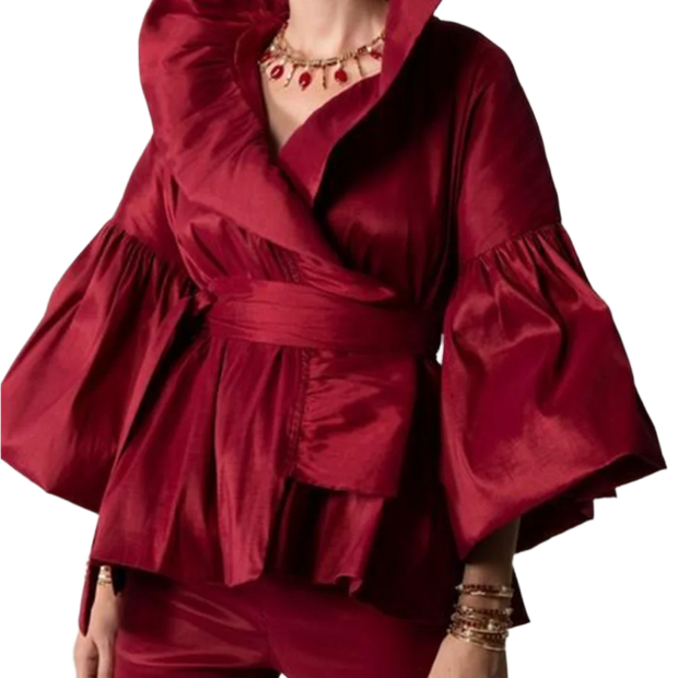 Red outfit with ruffled sleeves on a plain background