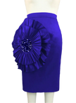 Blue skirt with a large floral embellishment on a mannequin against a gray curtain background