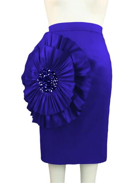 Blue skirt with a large floral embellishment on a mannequin against a gray curtain background