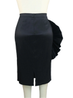 Black skirt on a mannequin against a gray curtain background