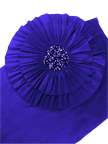 Blue fabric with a pleated design and sequin center on a white background