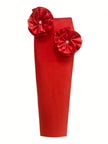 Red clutch with floral embellishments on a white background