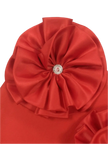 Red fabric with a decorative flower and gemstone center on a gray background