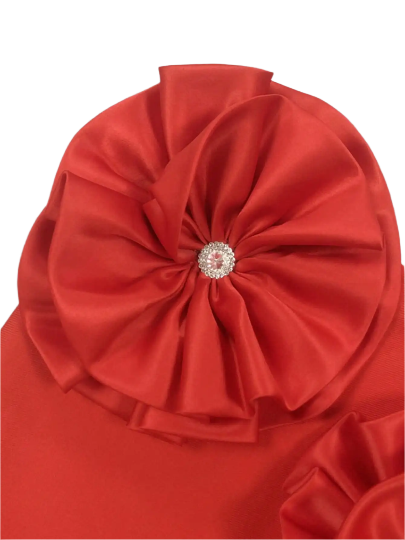 Red fabric with a decorative flower and gemstone center on a gray background
