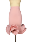 Pink skirt with ruffled bottom on a mannequin against a dark background