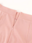 Close-up of a pink garment with a zipper on a white background