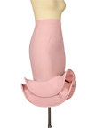 Mannequin wearing a pink skirt against a dark background