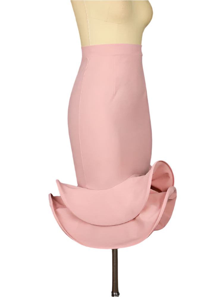 Mannequin wearing a pink skirt against a dark background