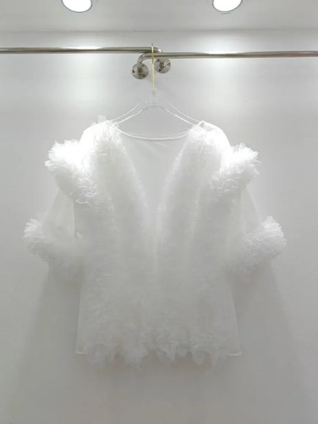 White lace top on a hanger against a white background