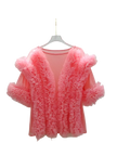 Pink textured cardigan on a hanger against a white background