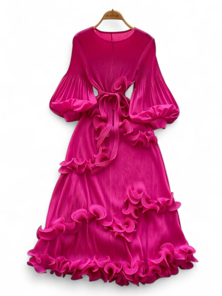 Fuchsia pink dress with ruffled layers on a white background