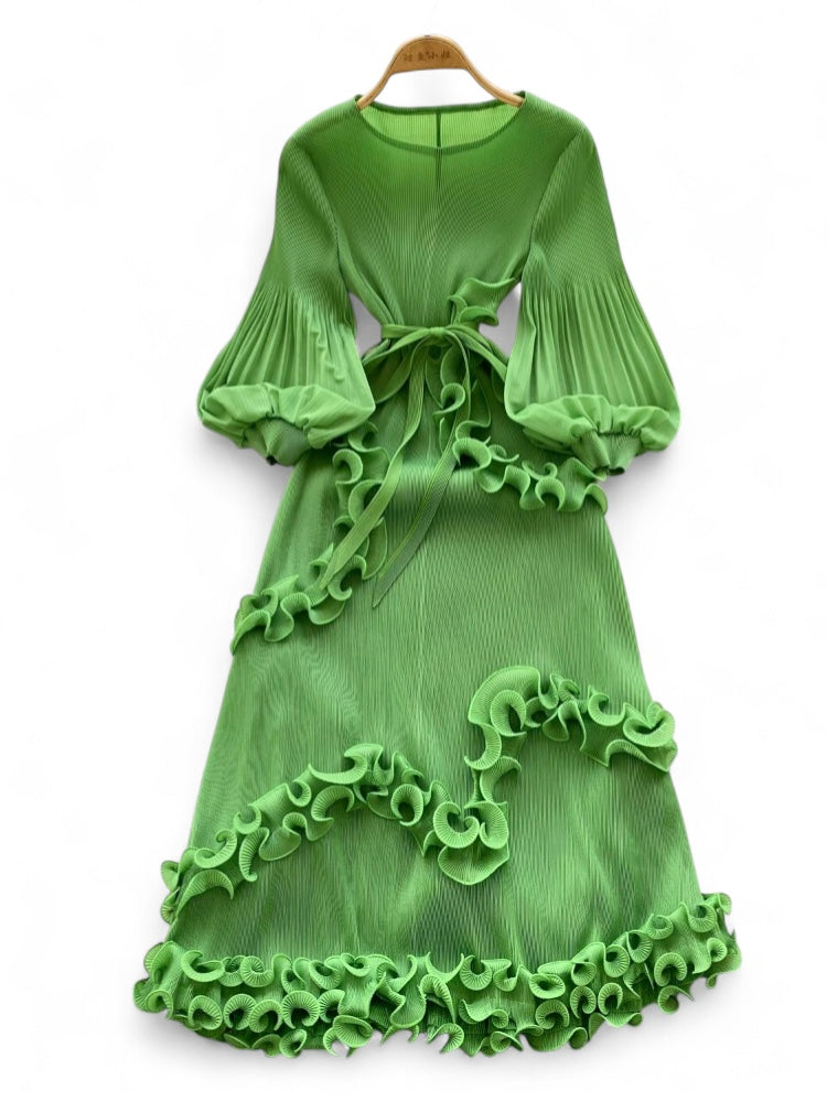 Green dress with ruffled details on a white background