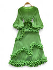 Green dress with ruffled details on a white background