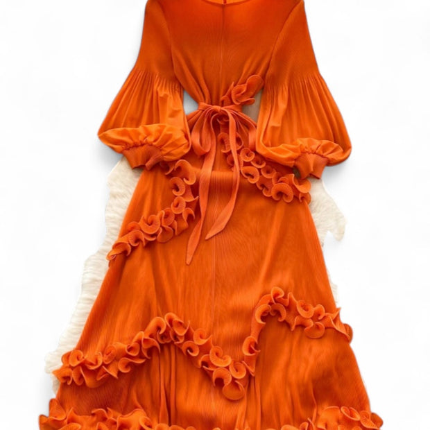 Orange dress with ruffled layers on a white background