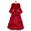 Red velvet dress with ruffled details on a white background