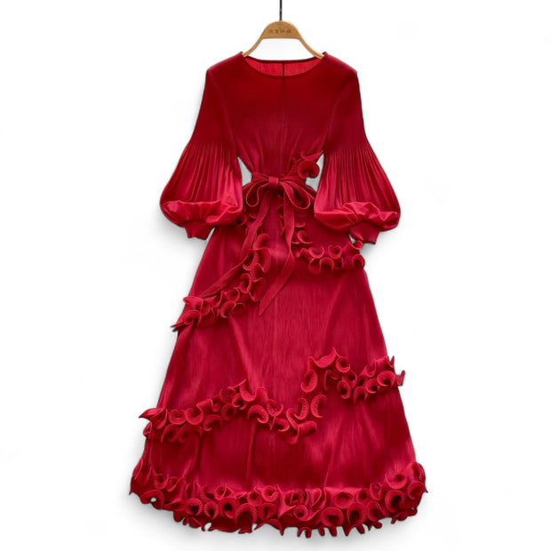 Red velvet dress with ruffled details on a white background