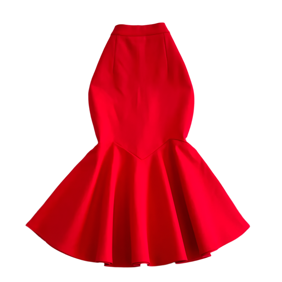 Red dress on a textured white surface with decorative elements.
