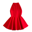 Red dress on a textured white surface with decorative elements.