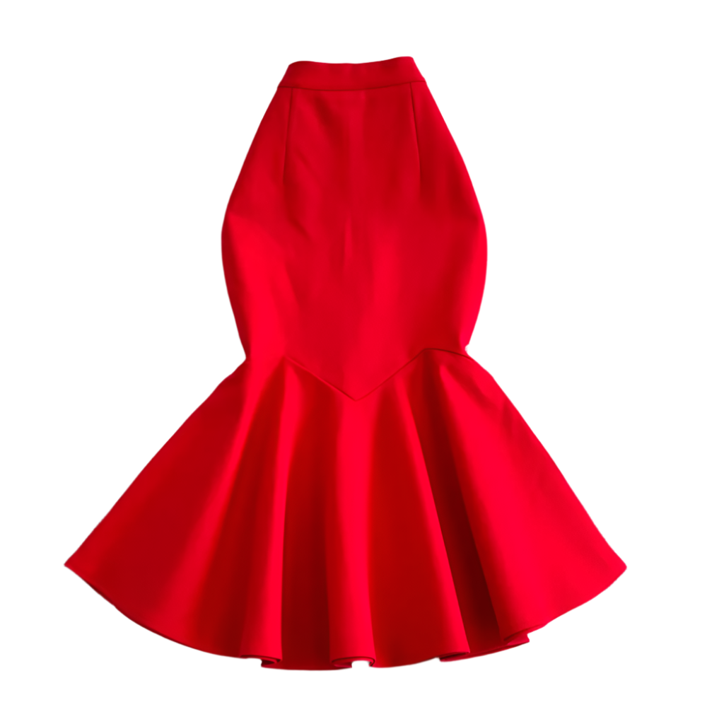 Red dress on a textured white surface with decorative elements.