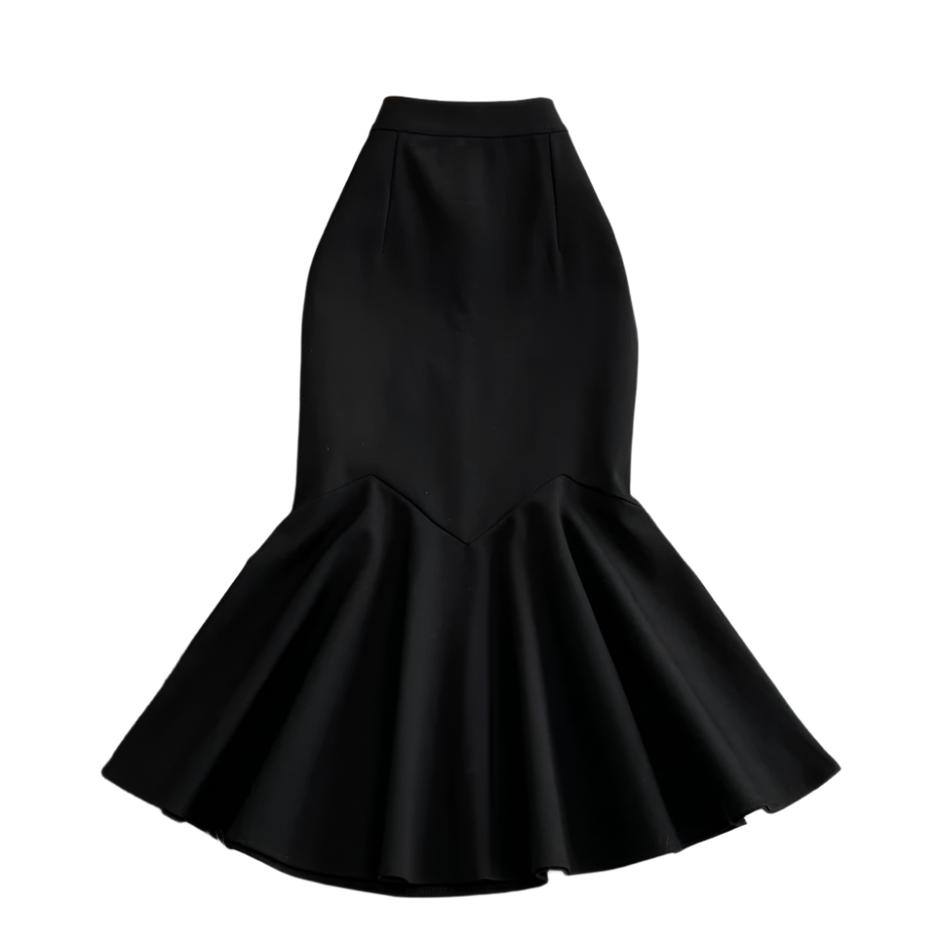 Black mermaid-style skirt on a textured surface with flowers.