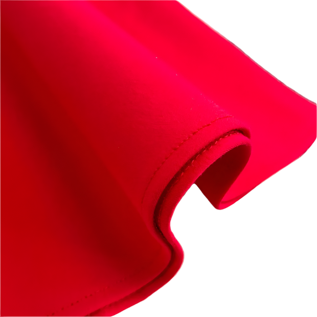 Close-up of red fabric on a textured surface