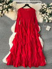 Red ruffled dress on a hanger with decorative flowers and fur rug in the background