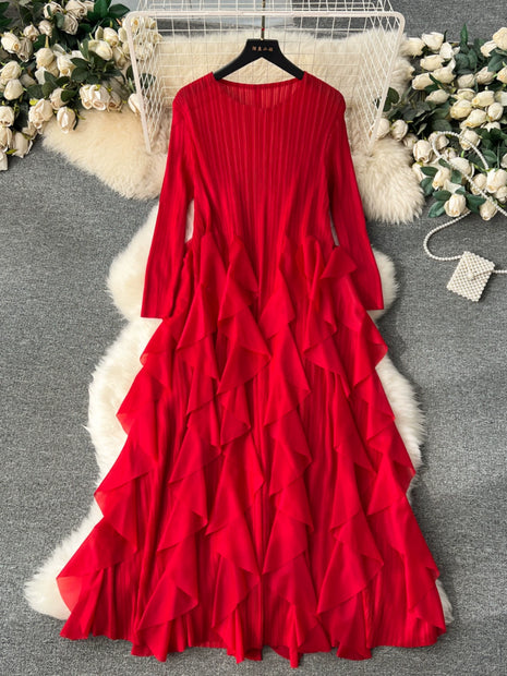 Red ruffled dress on a hanger with decorative flowers and fur rug in the background
