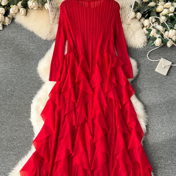 Red ruffled dress on a hanger with decorative flowers and fur rug in the background