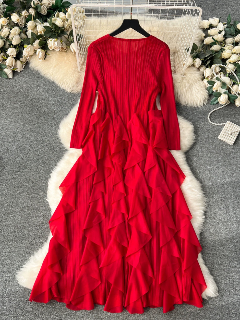 Red ruffled dress on a hanger with floral decorations in the background