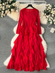 Red ruffled dress on a hanger with floral decorations in the background