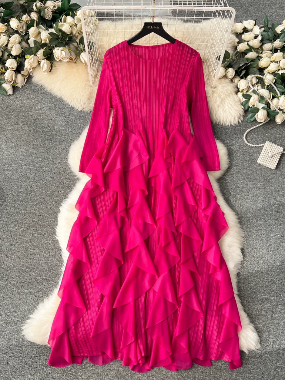 Fuchsia ruffled dress on a hanger with decorative flowers in the background