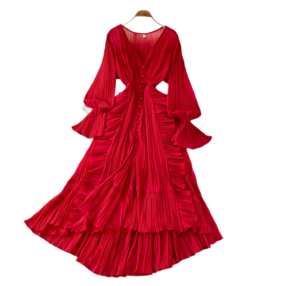 Red pleated dress on a hanger against a neutral background