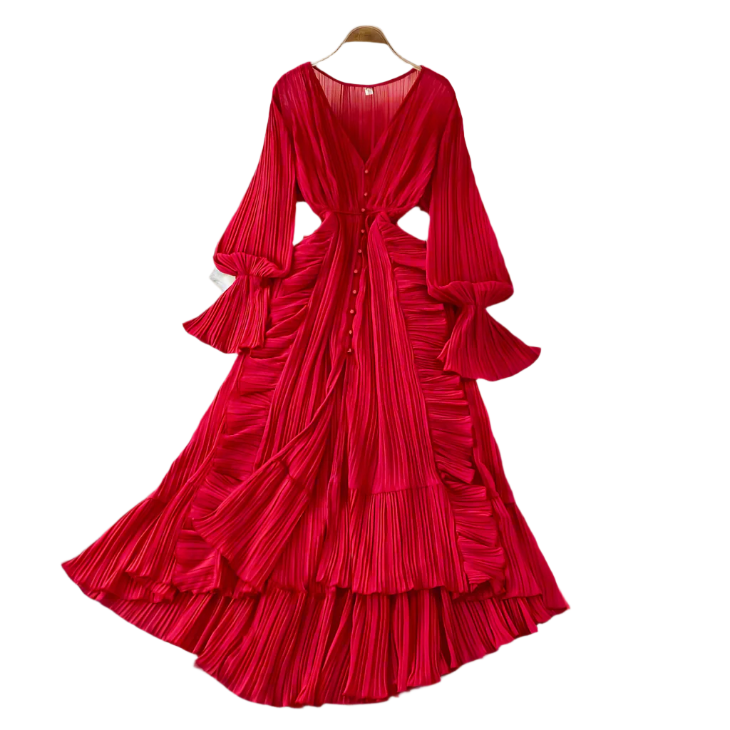 Red pleated dress on a hanger against a neutral background